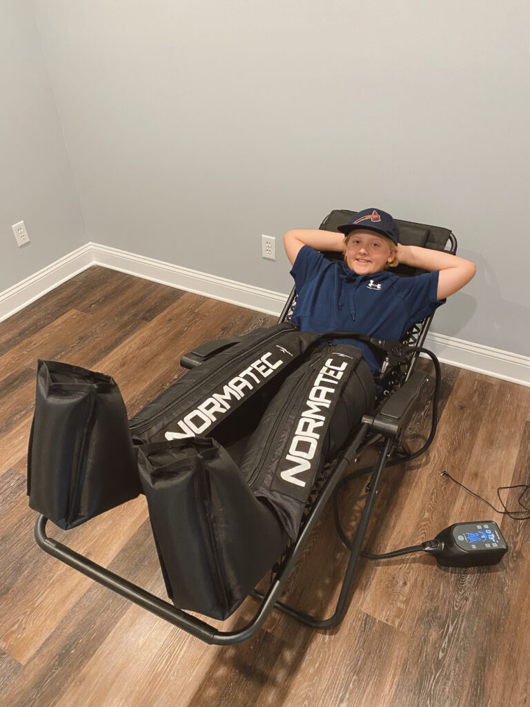 Youth athlete using Normatec compression therapy