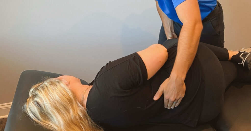 Chiropractor Helping Patient With Back Pain