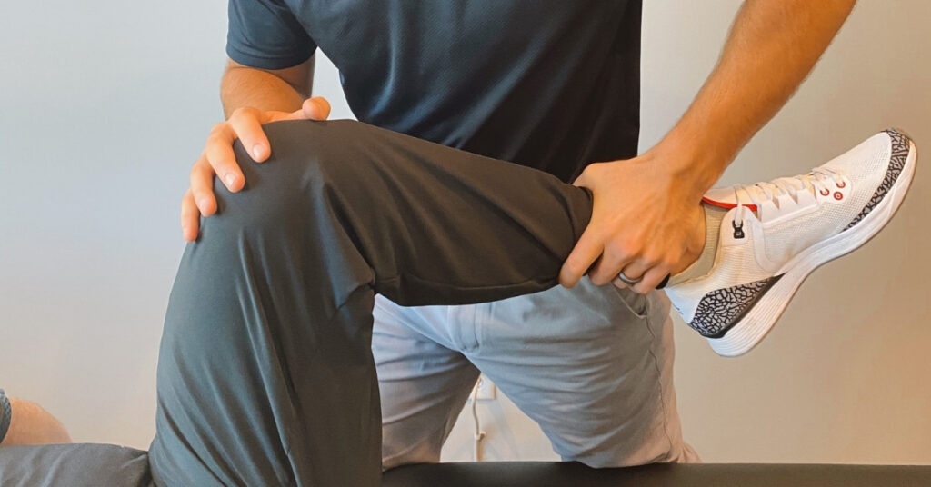 Chiropractor Helping Patient With Knee Pain