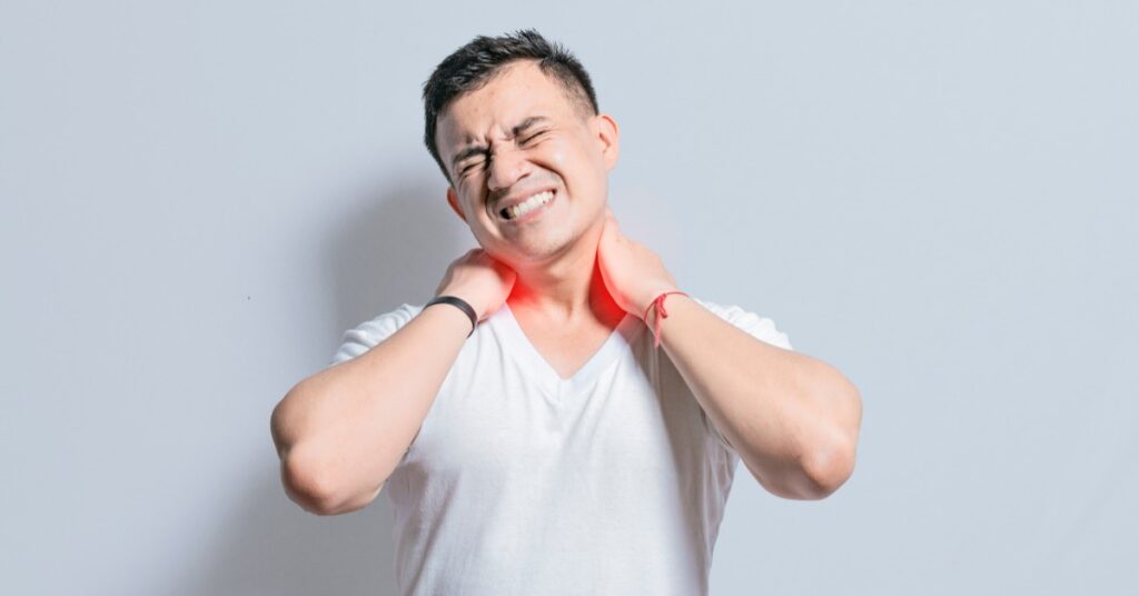 Man with Neck Pain Grabbing His Neck | Neck Pain Relief | St. Johns Chiropractic & Performance