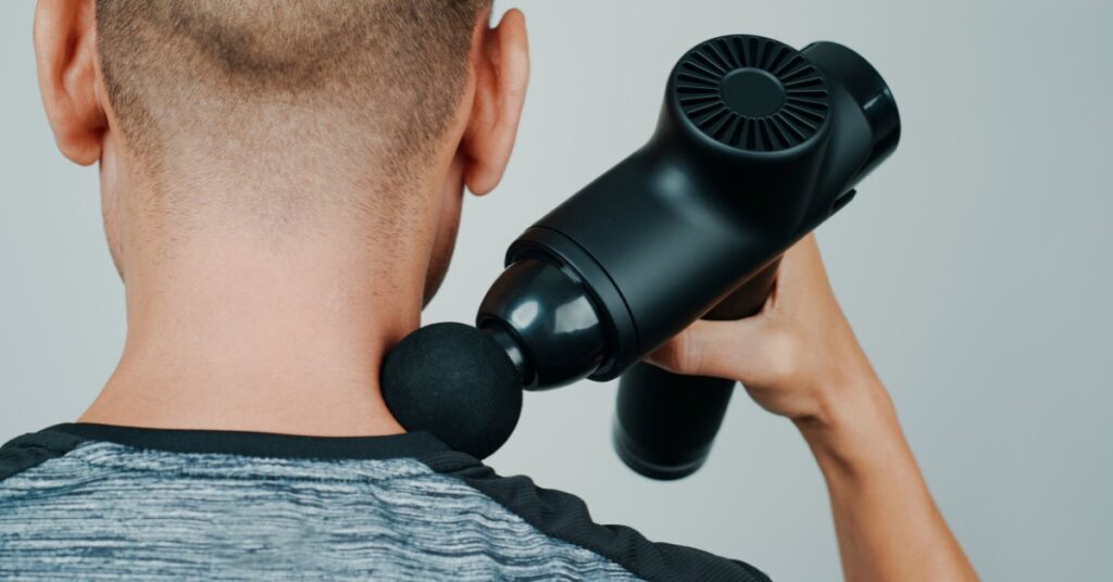 Massage Gun Being Used to Help with Neck Pain | Relieve Neck Pain | St. Johns Chiropractic & Performance