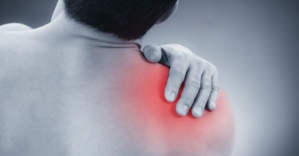 Man with Shoulder Pain Grabbing His Shoulder | Shoulder Pain Relief | St. Johns Chiropractic & Performance