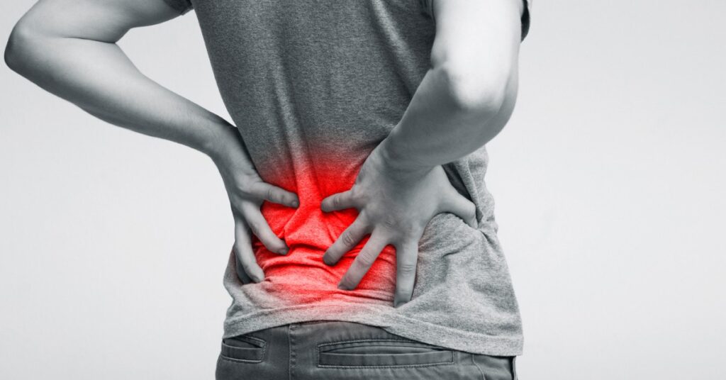 Person With Sciatica Pain Grabbing Their Back | Sciatica Pain Relief | St. Johns Chiropractic & Performance