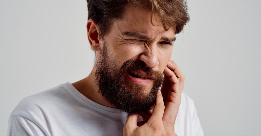 Man Grabbing His Jaw in Pain | Jaw Pain | St. Johns Chiropractic & Performance