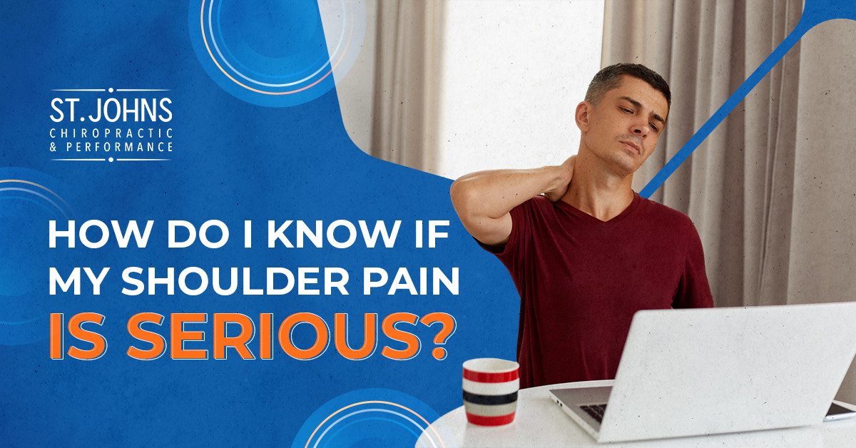 Man Sitting At A Desk With a Laptop and Coffee Mug Grabbing His Neck and Shoulder in Discomfort | How Do I Know If My Should Pain Is Serious? | Serious Shoulder Pain | St. Johns Chiropractic & Performance