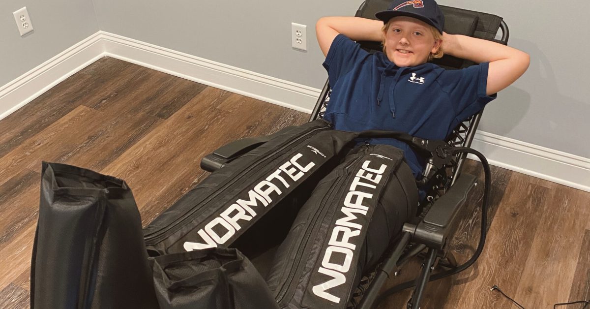 Youth athlete using Normatec compression therapy